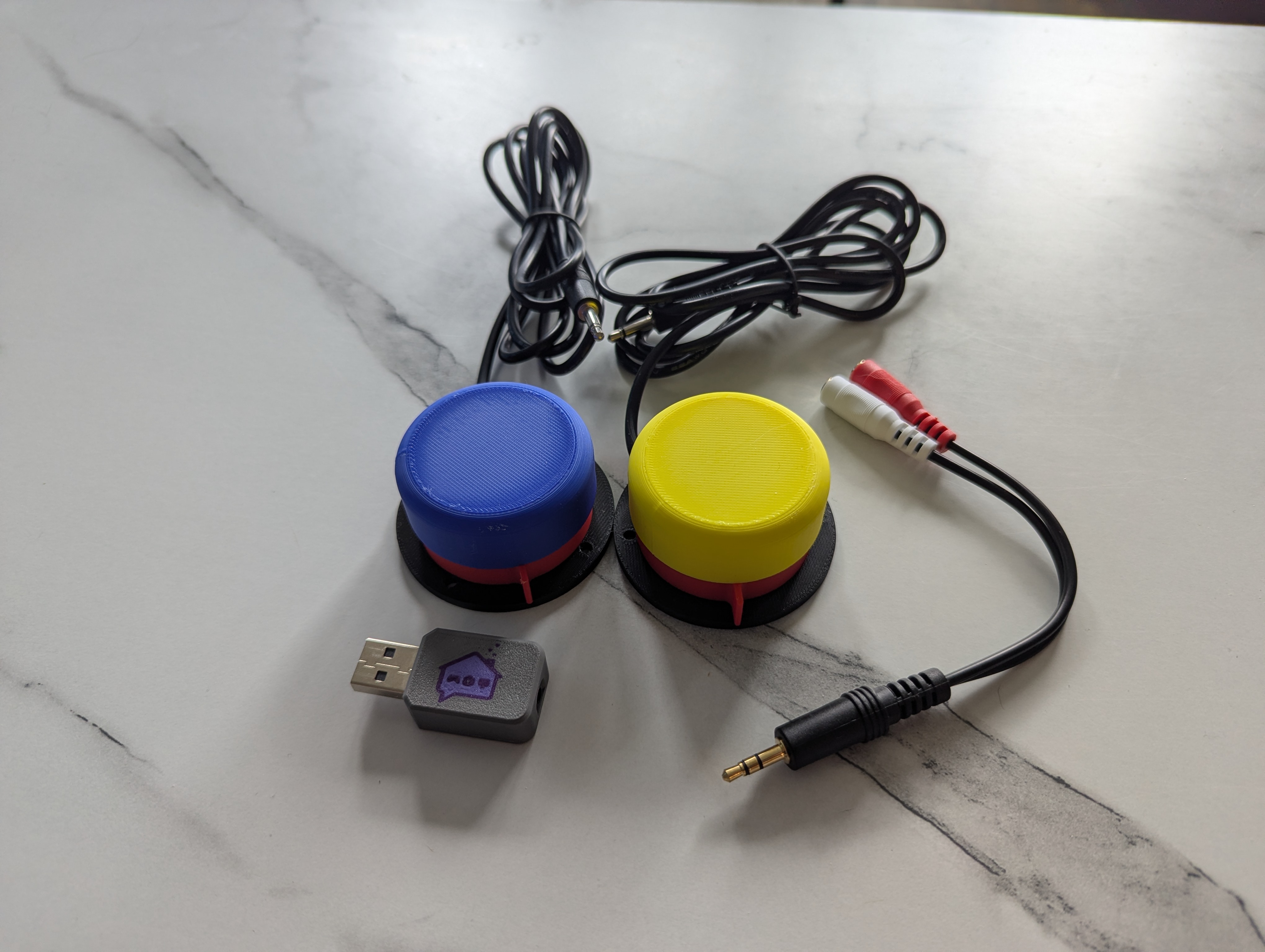 NARBE Foundation 2-Switch Kit contents showing two accessibility switches, USB adapter, and splitter cable